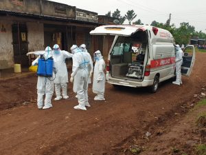 COVID-task-officials-pick-a-body-in-Masaaka-trading-centre